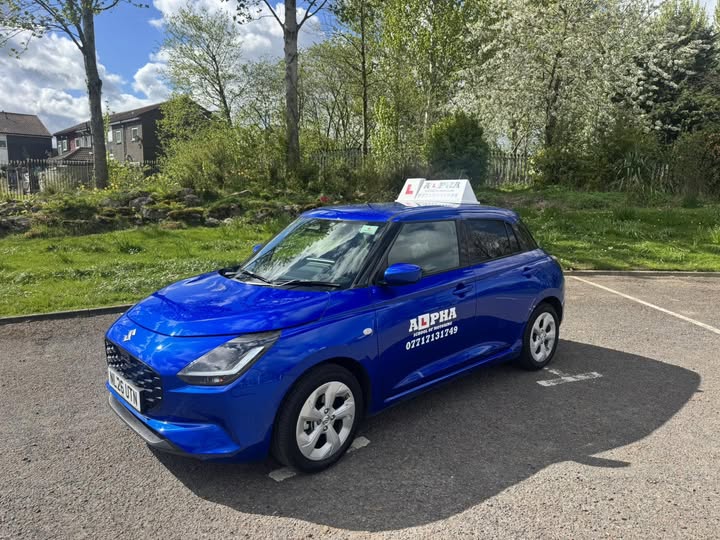 Blue Suzuki Swift tuition car with ALPHA School of Motoring branding